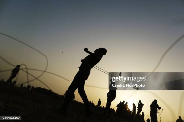 Palestinians protesters during clashes with Israeli topps near the border with Israel in the east of Gaza City on, 13 April 2018. According to local...