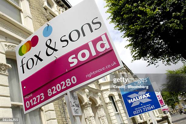 Collection of estate agents signs, showing residential properties for sale and sold, are lined up in Tisbury Road, Hove, West Sussex, U.K., on...