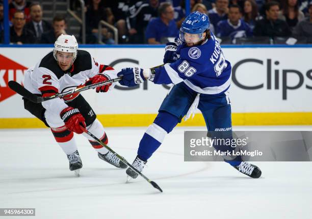Nikita Kucherov of the Tampa Bay Lightning skates against John Moore of the New Jersey Devils in Game One of the Eastern Conference First Round...