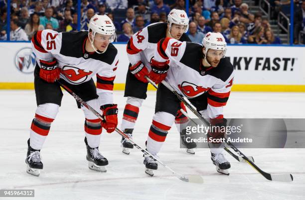 Mirco Mueller and Brian Gibbons of the New Jersey Devils skates against the Tampa Bay Lightning in Game One of the Eastern Conference First Round...