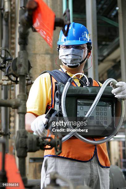 Worker checks refining equipment in a China Petroleum Corp. Refinery at Taoyuan, Taiwan, on Tuesday, May 15, 2007. CPC Corp., Taiwan, the island's...