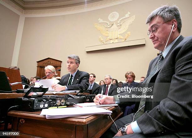 Stenographer, right, takes notes as Robert M. McDowell, commissioner of the Federal Communications Commission , center, and Deborah Taylor Tate,...