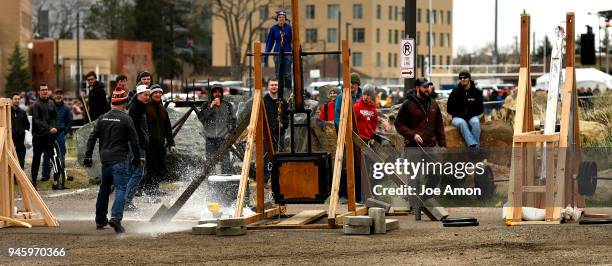 Taylor Keller holding the firing line and looking at his floating arm trebuchet, "The Jug Chucker" as his shot explodes near the Mile High Flyer...