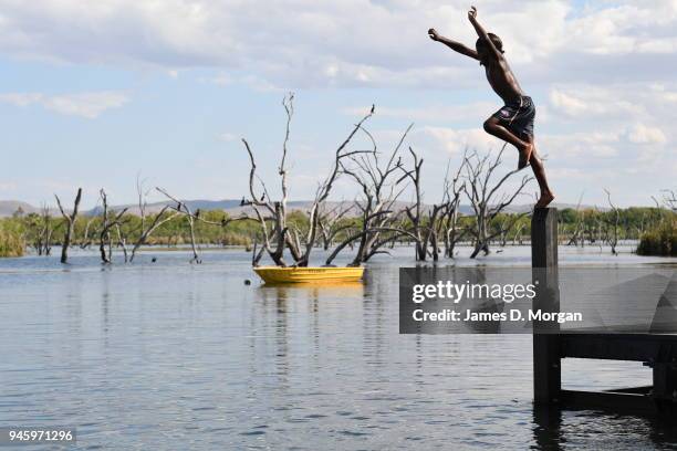 Locals enjoy a Sunday afternoon off jumping into the Lake and fishing in one of the river crossings close to the town on September 25, 2016 in...