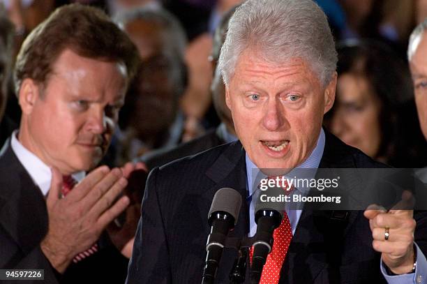 Jim Webb, U.S. Senatorial candidate from Virginia, left, listens and applauds as former U.S. President Bill Clinton speaks during the final campaign...