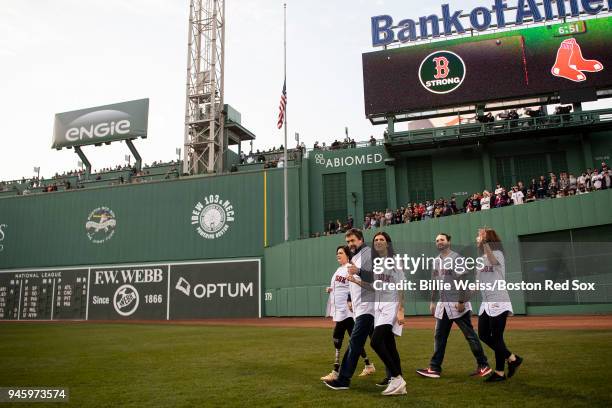 Boston Marathon bombing survivors Celeste, Kevin, Sydney, and Tyler Corcoran are introduced during a ceremony before a game between the Boston Red...