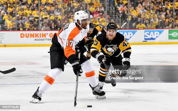 Wayne Simmonds of the Philadelphia Flyers handles the puck against Conor Sheary of the Pittsburgh Penguins in Game Two of the Eastern Conference...