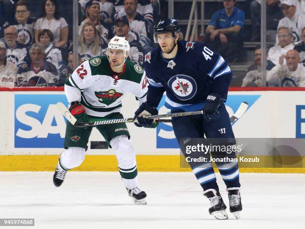 Nino Niederreiter of the Minnesota Wild and Joel Armia of the Winnipeg Jets keep an eye on the play during first period action in Game Two of the...