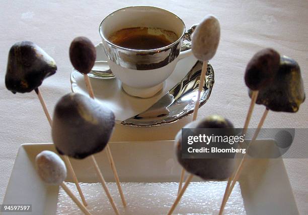 Chocolate-coated fruit perched on long sticks, resembling mushrooms, is served with coffee at the Schwarzwaldstube restaurant in the Traube Tonbach...