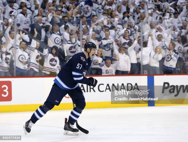 Tyler Myers of the Winnipeg Jets celebrates scoring against the Minnesota Wild in Game Two of the Western Conference First Round during the 2018 NHL...