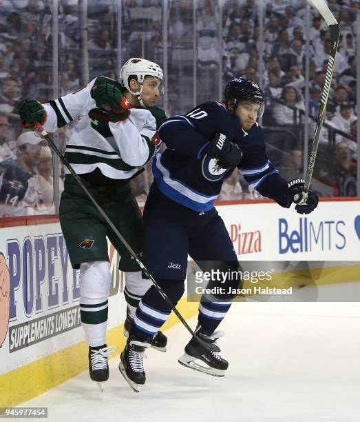 Joel Armia of the Winnipeg Jets hits Carson Soucy of the Minnesota Wild in Game Two of the Western Conference First Round during the 2018 NHL Stanley...