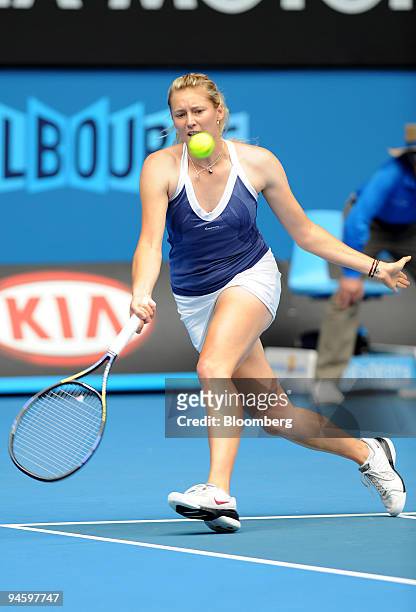 Olga Poutchkova of Russia looks to return the ball to Justine Henin of Belgium on day three of the Australian Open tennis tournament in Melbourne,...