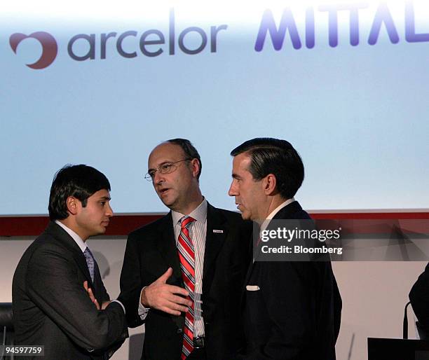 Mittal Steel Co. President and Chief Financial Officer Aditya Mittal, left, speaks to Arcelor Deputy Chief Executive Officer Michel Wurth, center and...