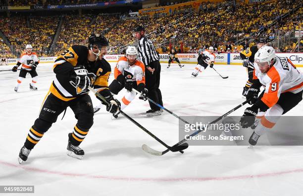 Sidney Crosby of the Pittsburgh Penguins and Ivan Provorov of the Philadelphia Flyers battle for the puck in Game Two of the Eastern Conference First...
