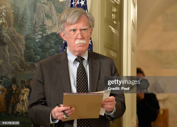 National Security Advisor John Bolton listens to remarks by U.S. President Donald Trump as he speaks to the nation, announcing military action...