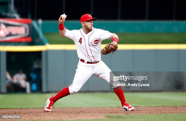 Cliff Pennington of the Cincinnati Reds throws the ball to first base against the St. Louis Cardinals at Great American Ball Park on April 13, 2018...