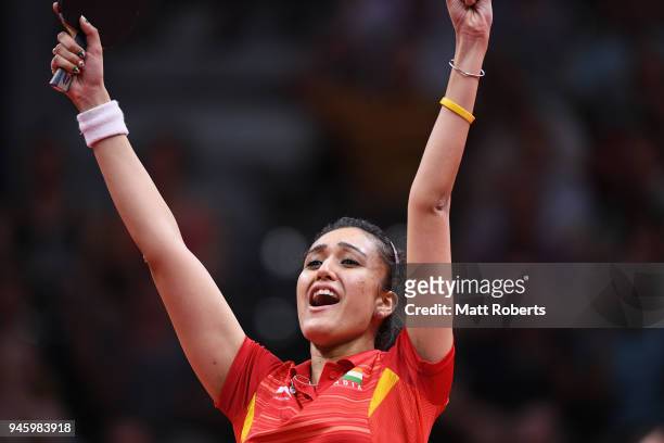 Manika Batra of India celebrates winning the Women's Singles semi-final Table Tennis match against Tianwei Feng of Singapore on day 10 of the Gold...