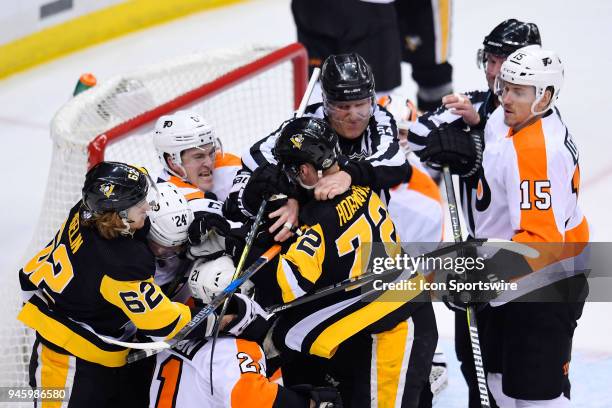 Pittsburgh Penguins right wing Patric Hornqvist and Pittsburgh Penguins left wing Carl Hagelin scrum with Philadelphia Flyers defenseman Travis...