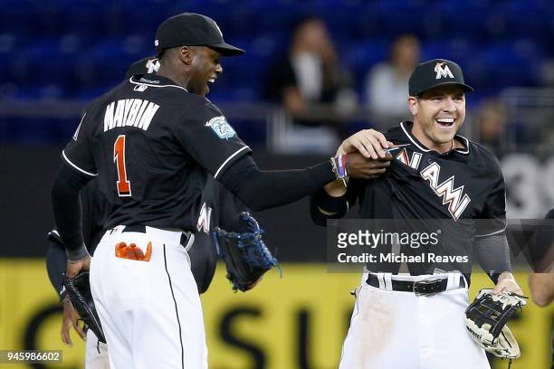Cameron Maybin of the Miami Marlins celebrates with J.B. Shuck after they defeated the Pittsburgh Pirates 7-2 at Marlins Park on April 13, 2018 in...