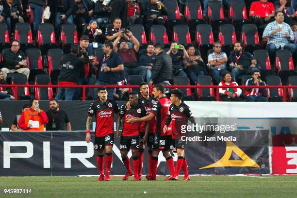 Miler Bolanos of Tijuana celebrates with teammates after scoring the first goal of his team during the 15th round match between Tijuana and Chivas as...