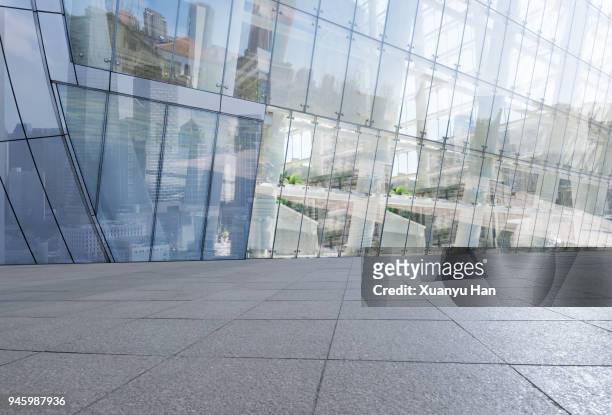glass wall with reflection of modern buildings in midtown of tianjin - new pavement stock pictures, royalty-free photos & images