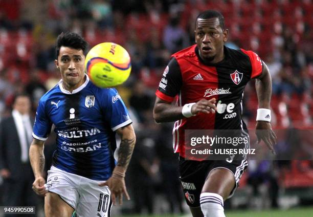 Leiton Jimenez of Atlas vies for the ball with Edson Puch of Queretaro during their Mexican Clausura 2018 tournament football match at the Jalisco...