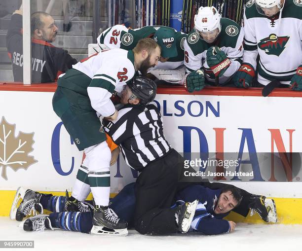 Brandon Tanev of the Winnipeg Jets fights Daniel Winnik of the Minnesota Wild in Game Two of the Western Conference First Round during the 2018 NHL...