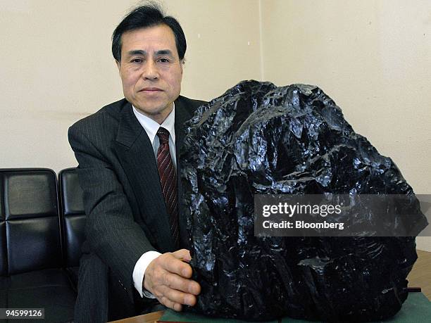 Toshi Koami, head of Yubari's Chamber of Commerce, poses with a lump of coal at his office in Yubari, Japan, on Tuesday, Mar. 13, 2007. "We moved on...