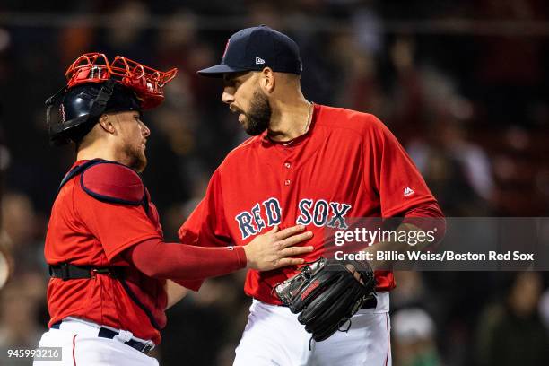 Matt Barnes of the Boston Red Sox celebrates a victory with Christian Vazquez against the Baltimore Orioles on April 13, 2018 at Fenway Park in...