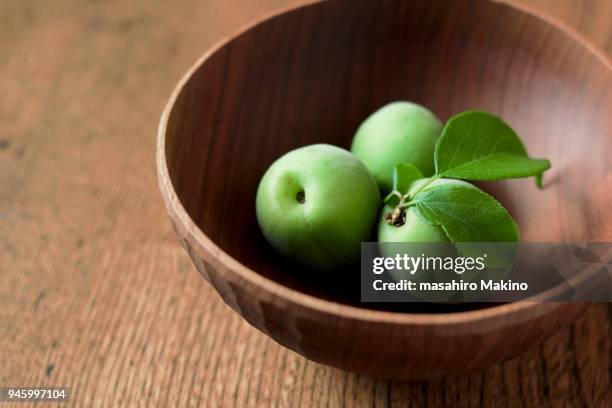 japanese plums in wooden bowl - prunus mume fotografías e imágenes de stock