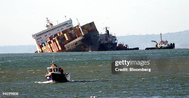 Small vessel passes the stricken ship the MSC Napoli seen off the coast at Branscombe in Devon, UK, Tuesday, Jan. 23 2007. The MSC Napoli, the...