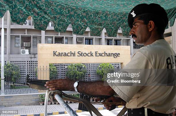 Pakistani soldier on a patrolling vehicle passes the Karachi Stock Exchange in Karachi, Pakistan on Friday, June 23, 2006. The Karachi Stock...