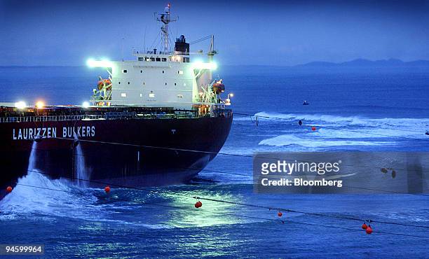 Towing cables are attached to the bulk tanker container ship Pasha Bulker during a night-time refloating attempt on Nobby's beach at the entrance to...