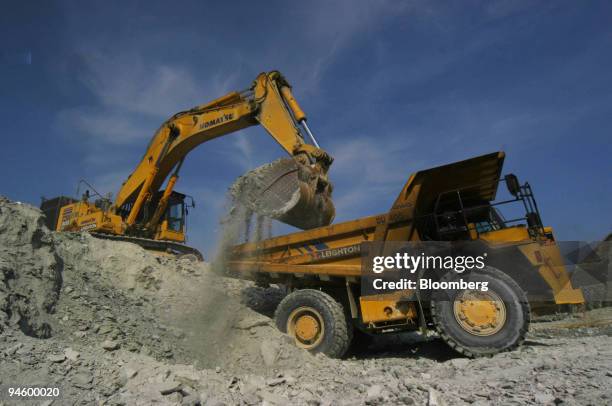 Workers operate heavy machinery at Lafayette Mining Ltd.'s copper, gold and silver open pit mining operation on Rapu Rapu Island, Philippines, on...