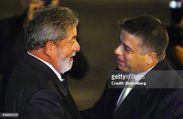 Luis Inacio Lula Da Silva, left, Brazil's president, is welcomed by Cuban Foreing Minister Felipe Perez Roque at the Jose Marti airport in Havana,...