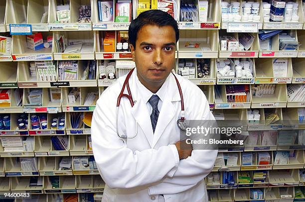 Dr. Rahul Koranne poses for a photograph at his office, in Maplewood, Minnesota, Thursday, June 22, 2006. Koranne's patient, Donald Zibell, takes...