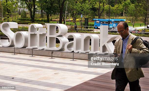 Man walks past a Softbank Corp. Sign in Tokyo, Japan, on Monday, May 7, 2007. Softbank Corp., Japan's third-biggest mobile-phone company, expects to...