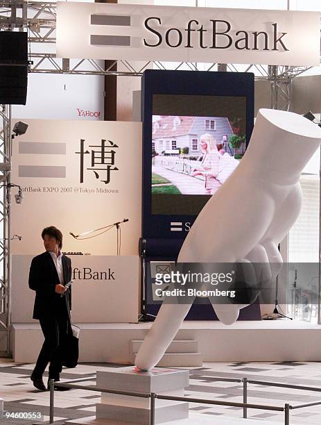 Man walks past a Softbank Corp. Sign in Tokyo, Japan, on Monday, May 7, 2007. Softbank Corp., Japan's third-biggest mobile-phone company, expects to...