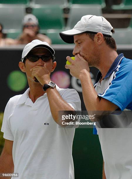Jeff Coetzee of South Africa, left, and Rogier Wassan of the Netherlands consult each other during their doubles match against brothers Mike and Bob...