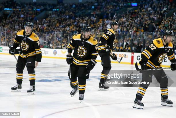 Boston Bruins right defenseman Charlie McAvoy , Boston Bruins left wing Brad Marchand and Boston Bruins center Patrice Bergeron get ready for a face...