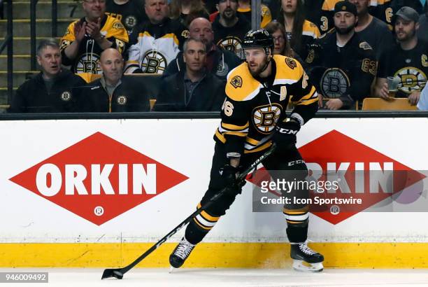 Boston Bruins center David Krejci holds the puck on the power play during Game 1 of the First Round for the 2018 Stanley Cup Playoffs between the...