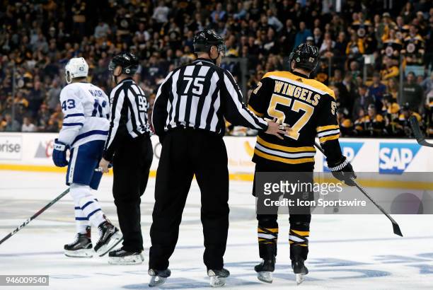 Boston Bruins winger Tommy Wingels is kept away from Toronto Maple Leafs center Nazem Kadri by linesman Derek Amell during Game 1 of the First Round...