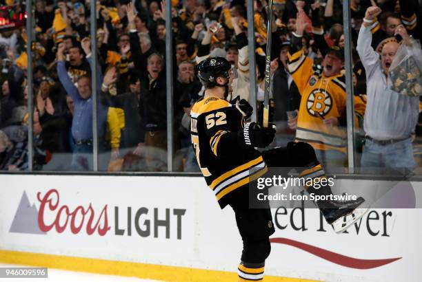 Boston Bruins center Sean Kuraly celebrates his goal with the fans during Game 1 of the First Round for the 2018 Stanley Cup Playoffs between the...