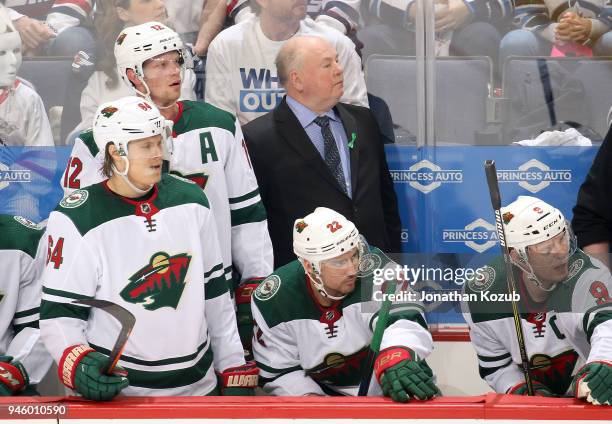 Head Coach Bruce Boudreau, Eric Staal, Mikael Granlund, Nino Niederreiter and Mikko Koivu of the Minnesota Wild looks on from the bench during second...