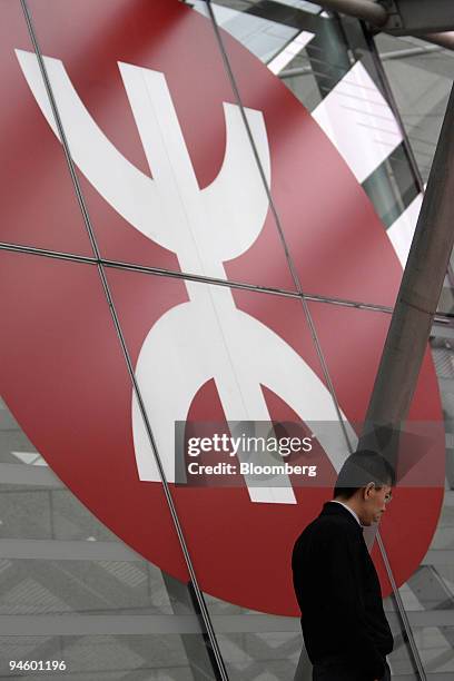 Man walks past the MTR Corp. Logo at Hong Kong Station in Hong Kong, China, on Tuesday, March 13, 2007. Just when Hong Kong investors are getting...