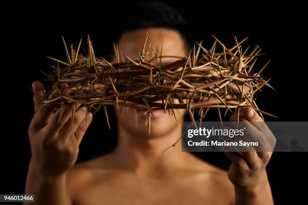 man holding a crown of thorns - asian man covering ears stock pictures, royalty-free photos & images