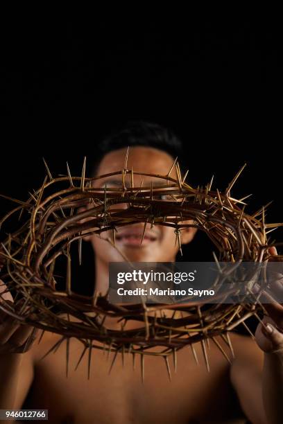 man holding a crown of thorns - asian man covering ears stock pictures, royalty-free photos & images