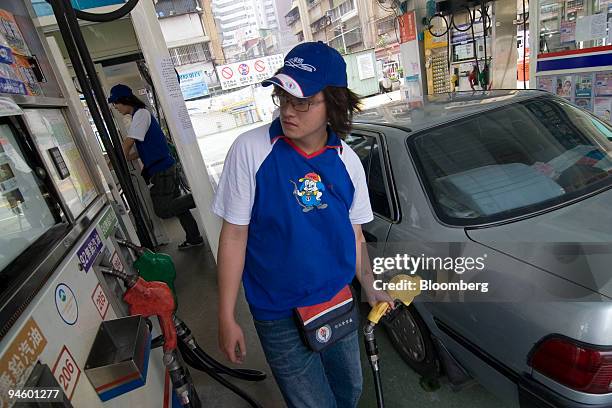 China Petroleum Corp. Employee Tseng Fei-hua adds fuel to a car at a CPC gas station, in Taipei, Taiwan, on Wednesday, May 9, 2007. CPC Corp.,...