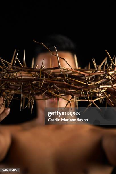 man holding a crown of thorns - asian man covering ears stock pictures, royalty-free photos & images