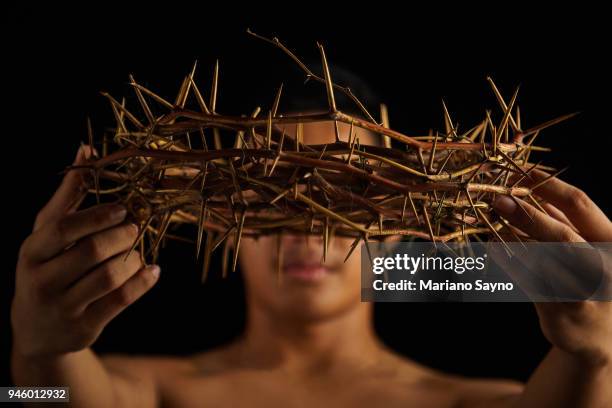 man holding a crown of thorns - asian man covering ears stock pictures, royalty-free photos & images